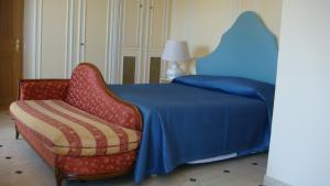 a bedroom with a blue bed and a red chair at Villa Manù B&B Chambre D'hote in Les Issambres +86 photos