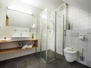 a bathroom with a shower and a toilet and a sink at Luxurious Apartment in Zell am See near Ski Area in Zell am See