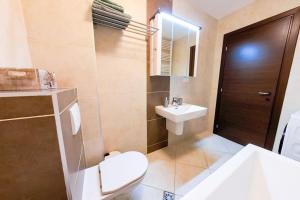 a bathroom with a white toilet and a sink at Bucharest Central D Apartment in Bucharest +17 photos