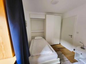 a small white room with a bed in it at Ferienwohnung Parsenn Peaks Panorama in Davos