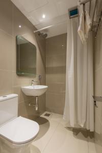 a bathroom with a toilet and a sink and a shower at STAYS HOTEL in Kuala Lumpur