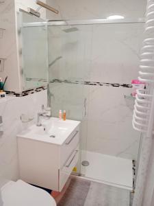 a white bathroom with a shower and a sink at 918A Warsaw Center Free Parking TAMARS in Warsaw