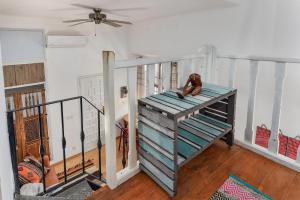 a room with a staircase with a dog sitting on it at A relaxed bohemian vibe in Old town in Marbella