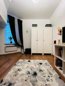 a living room with white cabinets and a large window at GREEN Apartment in Riga