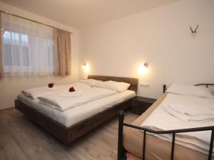 two beds in a hotel room with flowers on them at Charming Apartment in Kirchberg in Tirol with Private Garden in Kirchberg in Tirol