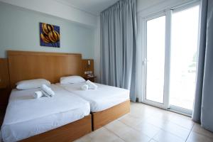 Postel nebo postele na pokoji v ubytování Kos Bay Hotel