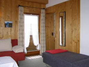 a bedroom with a bed and a window with at Landhaus Brigitta in Innsbruck