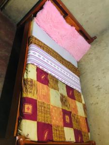 a wooden box with a blanket on top of it at Kiharas Farm stay in Nairobi