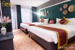 Postel nebo postele na pokoji v ubytování Swan Sapa Hotel