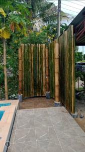 a bamboo fence in front of a pool at Sunanta Bungalow in Ko Lanta