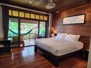 a bedroom with a large bed and a balcony at Salad Hut in Salad Beach +108 photos