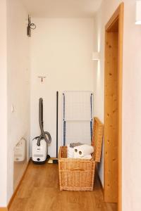 um quarto com uma cesta de vime e um ferro de engomar em Appartements neben der Gondelbahn - Haus Nord em Brixen im Thale