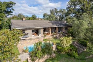 an aerial view of a house with a swimming pool at Tygerfontein Safari Villa in Amakhala Game Reserve