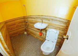 a bathroom with a toilet and a sink at Adventourist Inn in Coron