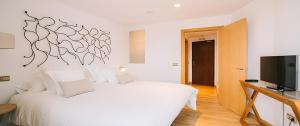 En eller flere senge i et værelse på Hotel Rural Quercus Tierra