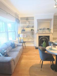 a living room with a couch and a fireplace at Foxhollow House in Blarney