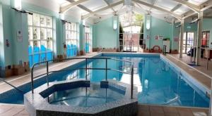 a large swimming pool in a building at Martha's Inn Cresswell in Cresswell