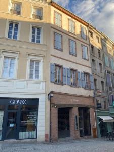 a large building on a street with a store at Appartement centre historique in Albi