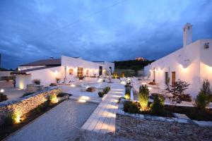 a lit up courtyard of a building at night at Montegusto in Castel del Monte