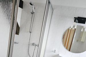 a shower with a round mirror in a bathroom at Friends&Family Veldenz M in Veldenz +18 photos