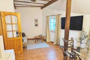a living room with a television and a table at Friends&Family Veldenz M in Veldenz
