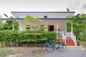 a couple of bikes parked in front of a house at Vawa Guesthouse in Kanchanaburi City