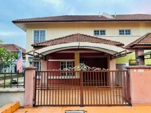 a home with a wooden gate and a house at Landed 3BR near Bangi Wonderland - Wi-Fi, Netflix in Kajang