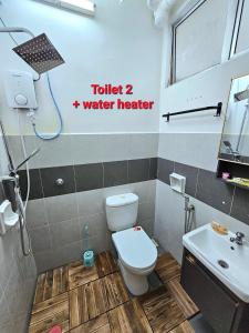 a small bathroom with a toilet and a sink at Dieyra Homestay in Kuala Terengganu