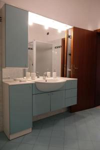 a bathroom with a sink and a mirror at il Quadrifoglio camere in stile vintage in Cesena