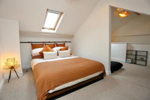 a bedroom with a large bed in a attic at Cwm Seren - Luxury Apartment in Crickhowell