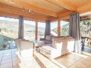 a living room with a couch and a table at Cosy Chalet in Stadl an der Mur with Valley Views in Stadl an der Mur