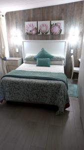 a bedroom with a large bed with a green blanket at Knysna Self Catering Accommodation in Knysna
