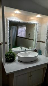 a bathroom with a sink and a large mirror at Knysna Self Catering Accommodation in Knysna