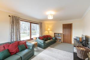 a living room with two couches and a television at Aonach in Kingussie