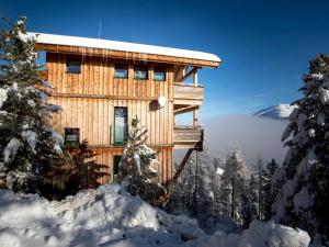 a log cabin in the snow with a view at Lovely Chalet in Turracherh he with Sauna in Turracher Hohe