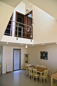 a dining room with a table and chairs and a staircase at Sea View Beachfront Villa Maria in Gouves