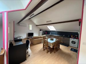 a living room with a table and a couch at Maisonnette privatisée in Sedan