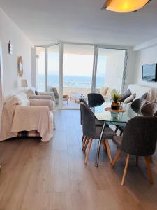 a living room with a table and a bed and a couch at Luz de Mar in Almería
