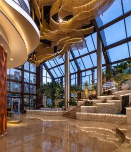 a lobby of a building with large windows at Mirage Hotel & Conference Center in Alexandria