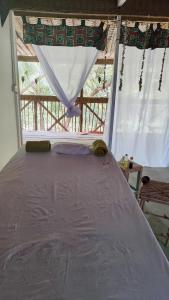 a large bed in a room with a window at blue lilu Kizimkazi in Kizimkazi