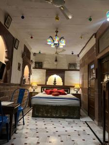 a bedroom with a bed and a table and chairs at Raj Mandir Boutique Home Stay in Jodhpur