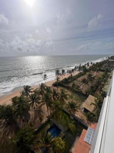 a view of a beach with palm trees and the ocean at PL BEACH FRONT APARTMENT in Bopitiya