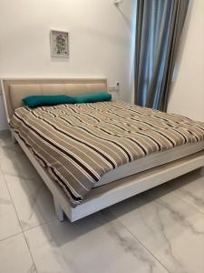 a large bed in a room with a bed frame at PL BEACH FRONT APARTMENT in Bopitiya