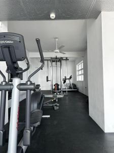 a gym with several treadmills and machines in a room at PL BEACH FRONT APARTMENT in Bopitiya