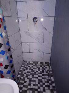 baño con aseo y suelo a cuadros en Hostel Villa Nova, en Mossel Bay