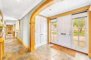 an arched hallway with white doors and windows at The Paddocks Romantic Retreat in Boston +12 photos