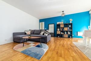 a living room with a couch and a table at Appartement near Disneyland Paris, 2 parking in Torcy