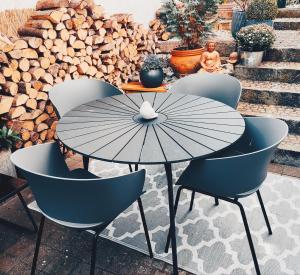 a table and chairs with an umbrella on a patio at Apartment for family & friends in Eisingen