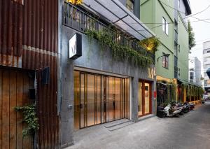 a building with plants on the side of a street at M Village Điện Biên Phủ Q3 in Ho Chi Minh City