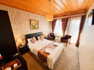 Postel nebo postele na pokoji v ubytování Eskibağ Butik Hotel